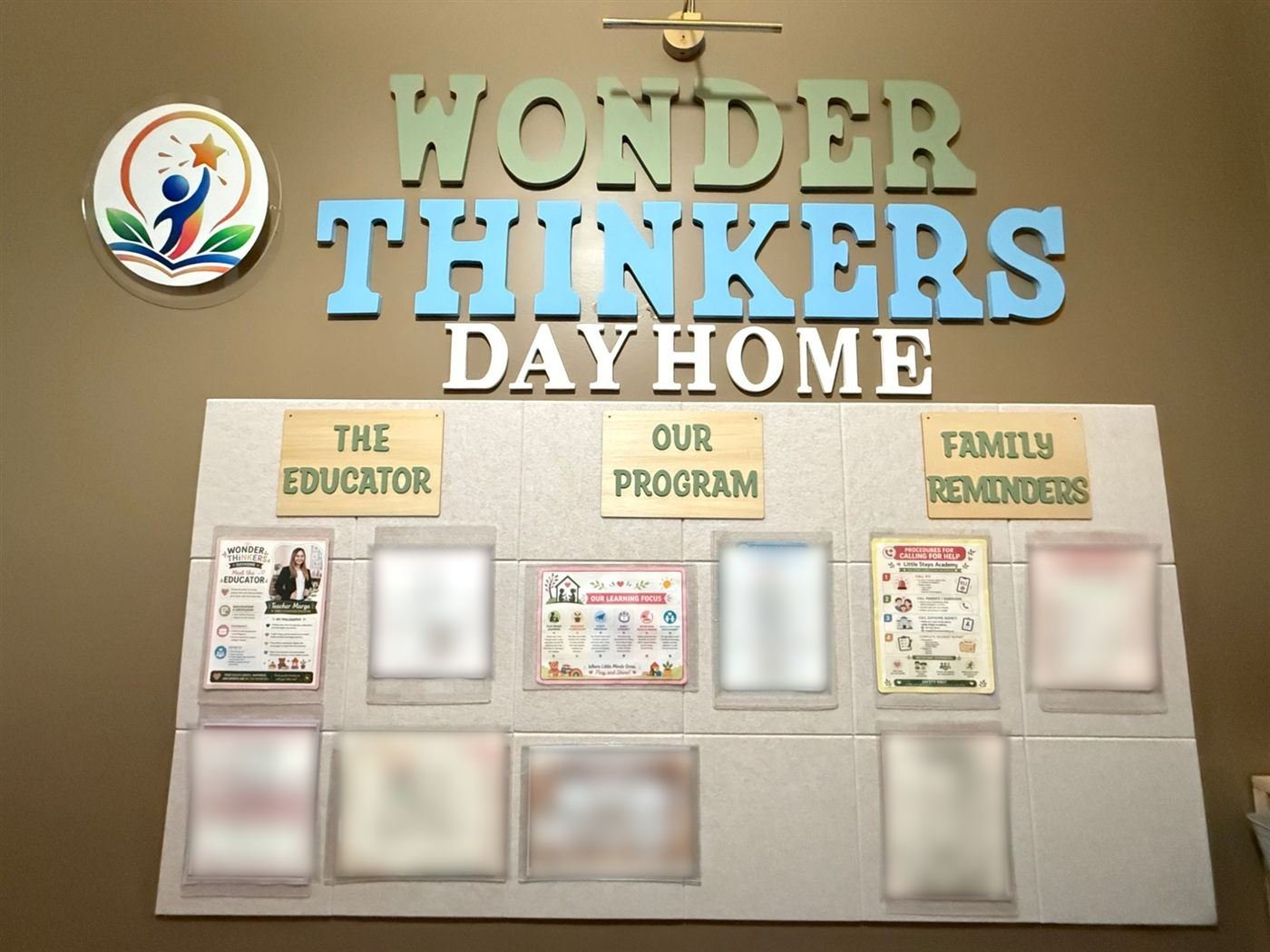 The Wonder Thinkers Dayhome landing wall with large wall lettering, the logo, and boards titled The Educator, Our Program and Family Reminders